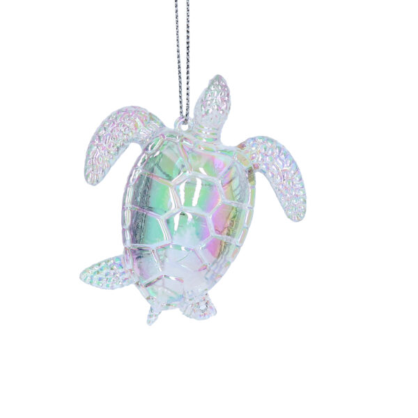 An iridescent sea turtle ornament hanging from a silver thread.