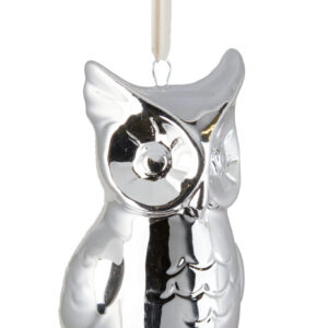 A silver owl ornament hanging on a white string.