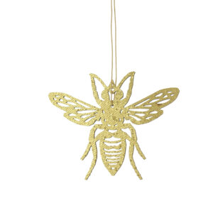 A gold bee ornament hanging from a string.