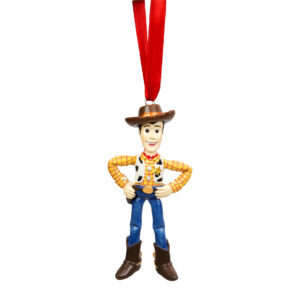 Woody from the Disney movie Toy Story hanging on a red ribbon. figure about 7cms tall. Woody is wearing his usual brown cowboy hat, yellow checked shirt with cow skin waistcoat, blue jeans and brown cowboy boots. Woody is standing with his hands on his hips.