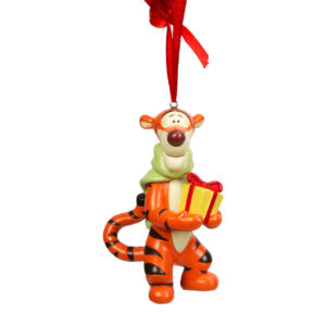 Disney's Tigger is an animation tiger who is orange with brown stripes and a pale yellow tummy and face. In this decoration he is carrying a yellow parcel with a red ribbon bow tied round it and he is wearing a pale green 'knitted scarf that is trailing down his back. He is tied to the tree using a red ribbon. 11cm's tall, acrylic.