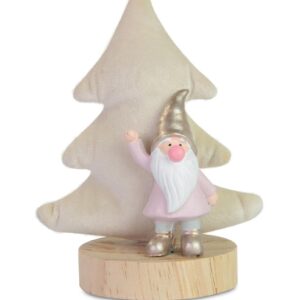 A waving poly resin gnome with pink coat and gold hat and boots stands in front on a cream coloured velour Christmas tree on a wooden plinth.