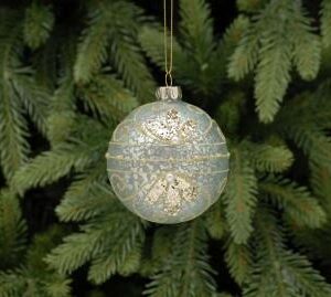 A white antique style glass Christmas bauble with raised gold swirl decoration and pearl bead adornments hanging on a gold string.