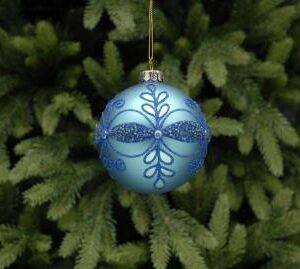 A matt blue christmas bauble with blue glitter leaf patterns and blue pearl detail hanging from a gold thread.