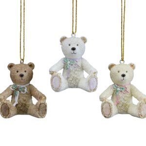 Three Victorian teddy bear tree decoration ornaments in various colours hanging on a chain.