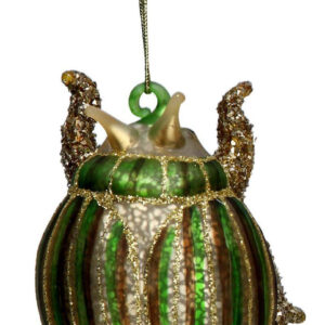 A blown glass, in antique gold, beetle tree decoration. It has a round body with green and brown vertical stripes across its back and neck with gold glitter detail and red diamante spots at the base. It hangs from a gold strings.