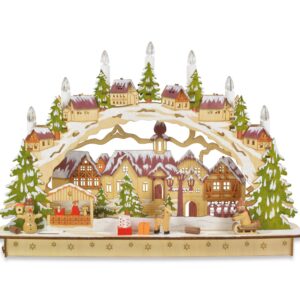 A colourful Germanic style Wooden Candle Arch Mantlepiece decoration with winter village scene featuring snow topped houses and Christmas trees and seven battery operated candles. The trees are coloured green and the rooftops orange.