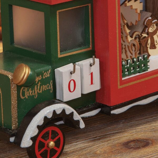 A wooden toy Christmas truck with an countdown advent calendar on it.