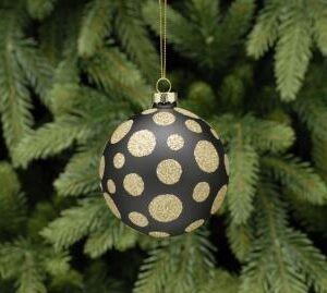 A matt black glass Christmas tree bauble decorated with gold glitter polka dots.