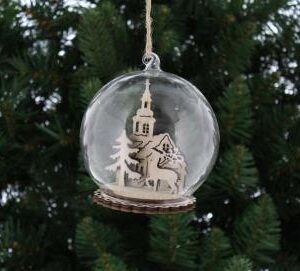 This rustic wooden scene features a handsome reindeer standing proud in front of a church and Christmas tree; beautifully enclosed within a glass dome, adding a beautiful touch of elegance. This decoration can either be hung as a bauble or sat as an ornament as it has a flat base.