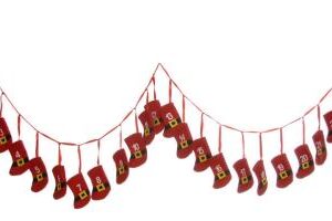 A string of Advent Christmas Stocking Bunting. 24 little red felt stockings with cute black santa belts with gold buckles hang from a red ribbon in a string of bunting. each stocking has a different number from 1- 24 in white felt, one for each day of advent.