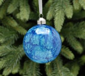 A glass Christmas tree bauble decorated in a bright blue marble effect.