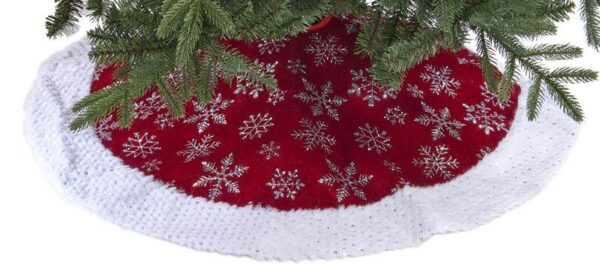 A round burgundy velour tree skiet decorated with sparkly silver snowflakes with a white velour trim decorated with silver sequins.