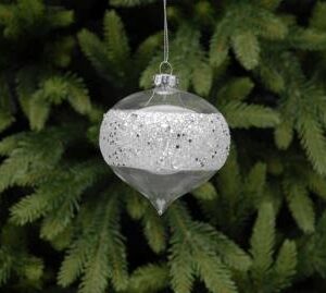 A clear glass onion shaped bauble with a very sparkly silver glitter band around the middle hanging from a tree.