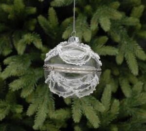 A clear glass trinket box Christmas tree bauble. This bauble is hinged in the middle so that the two halves open to reveal a space for hiding trinkets or treasure. The ouside of the bauble is decorated with swags made from diamante jewels, white beads and glitter. it hangs on a silver thread.