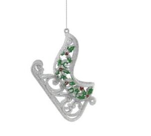 A plastic glitter silver sleigh hanging tree decoration with green holly leaves and red berry decoration on the side hanging from a silver string.