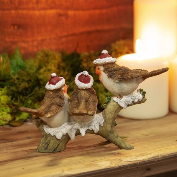 A view from behind of our ceramic figurine of Three Robins on a Branch. These jolly robins are all wearing traditonal Santa hats as they perch upon this snowy branch. They are decorated with a light dusting of gold glitter.