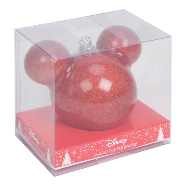 A clear plastic box containg a red glitter bauble in the shape of Disney's Mickey Mouse's headand ears. The bauble sits on a red cardboard plinth inside the box that is decorated with yellow and white stars and trees. The text on the plinth reads 'Disney SHAPED GLITTER BAUBLE' in white.