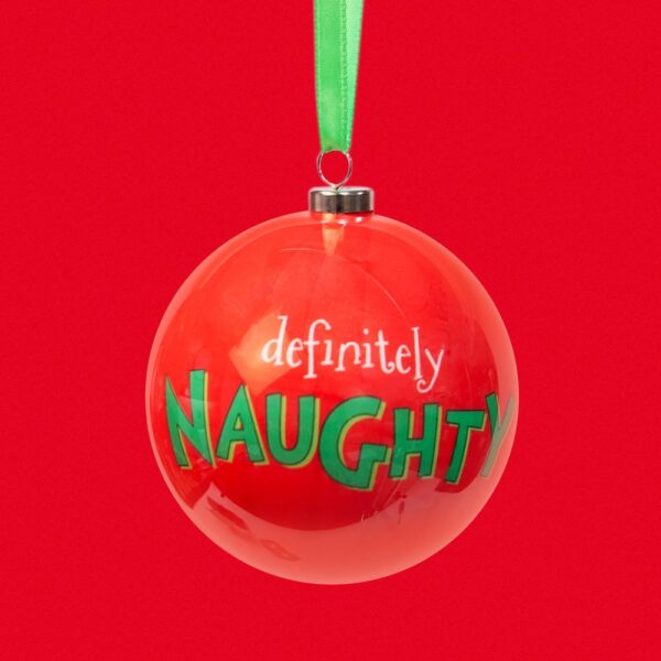 A decoupage christmas tree baubles from 'The Grinch' collection. The bauble is red and has text on it that reads 'definitely NAUGHTY', it hangs from a green ribbon. Shown against a red background.