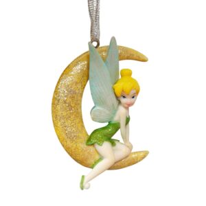 Disney's Tinkerbell from Peter Pan Hanging Christmas Tree Decoration. Tinkerbell sits poised upon a glittery yellow cresent moon hanging from a silver ribbon. She is wearing her trademark green dress and slippers which have accents of gold glitter on them. Her delicate pale blue wings sit proudly behind her and her elfish face peeks our from beneath her blond hair which is tied up in a bun.