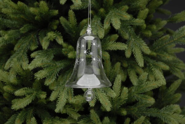 A clear glass Christmas tree bauble in the shape of a bell. The bell has etched stars around the top with silver diamante jewles in the centres of them. At the bottom there is a round clear glass clanger hanging from the bell.