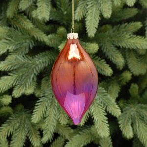 A red and pink ombre coloured, teardrop shaped glass Christmas tree bauble with a twist hanging from a gold string.