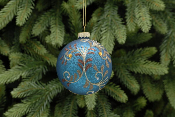 A blue antique style glass Christmas tree bauble decorated with pale gold glitter vines featuring copper and dark glod glitter leaves and gold and white diamante berries. Hanging on a gold string.