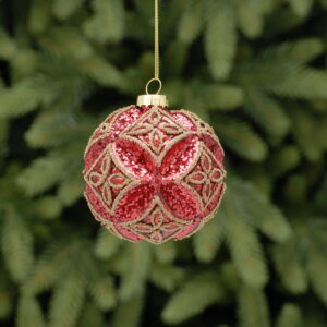 A moulded glass Christmas bauble with an embossed flower pattern. Covered in red glitter and featuring matt gold bead detail in a diamond pattern. Hanging from a gold thread.