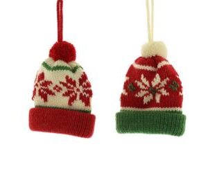 Knitted Christmas tree decorations. These nordic style wooly hats both feature a snowflake design on the hat and a pompom on the top. The one on the left is predominately white with a red snowflake design, green piping, a red cuff and pompom. it hangs from a red string. The one on the right is predominately red with a white snowflake design, white piping, a green cuff and white pompom. It hangs from a white string.