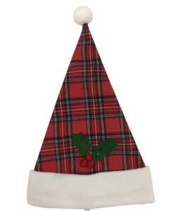 A red tartan, fabric santa hat with two green felt holly leaves and three red pompom berries on it. The hat has a large white band around the bottom and a matching white pompom on the tip.