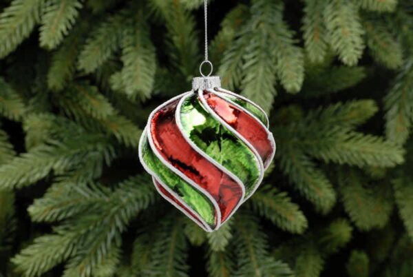 An onion shaped, twisted and segmented blown glass Christmas tree bauble decorated in alternating metallic red and green segments with white glitter detail along each ridge.