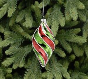 A teardrop shaped, twisted and segmented blown glass Christmas tree bauble decorated in alternating metallic red and green segments with white glitter detail along each ridge.