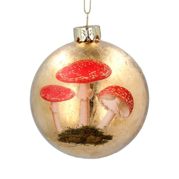 A glass Christmas tree bauble covered in gold leaf and decorated with a hand painted image of three fly agaric Toadstools. The toadstools are growing form a clump of green moss and their bright red caps and white stalks compliment the gold background.