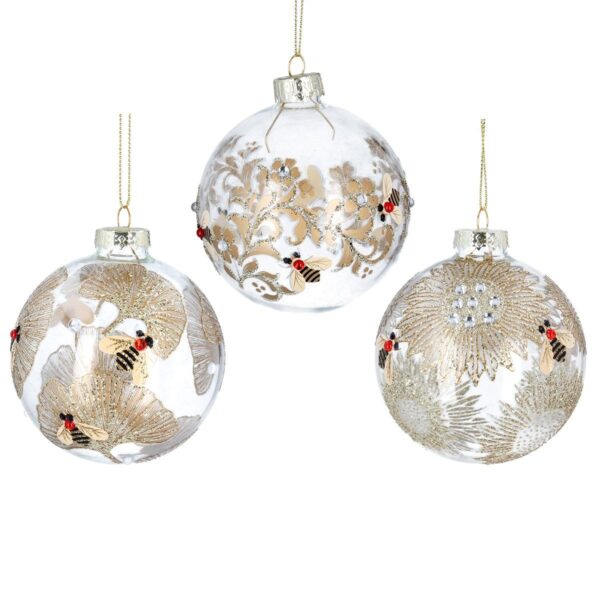 A set of clear glass Christmas tree baubles with gold floral bee designs. The bauble on the left has gold Ginko leaves with gold and black bees with red diamante jewels, the bauble in the centre has gold vines with small flowers that have clear diamante centres surrounded by gold and black bees with red diamante jewels and the bauble on the right has large gold sunflowers with clear diamante centres surrounded by gold and black bees with red diamante jewels. All hang from gold strings.