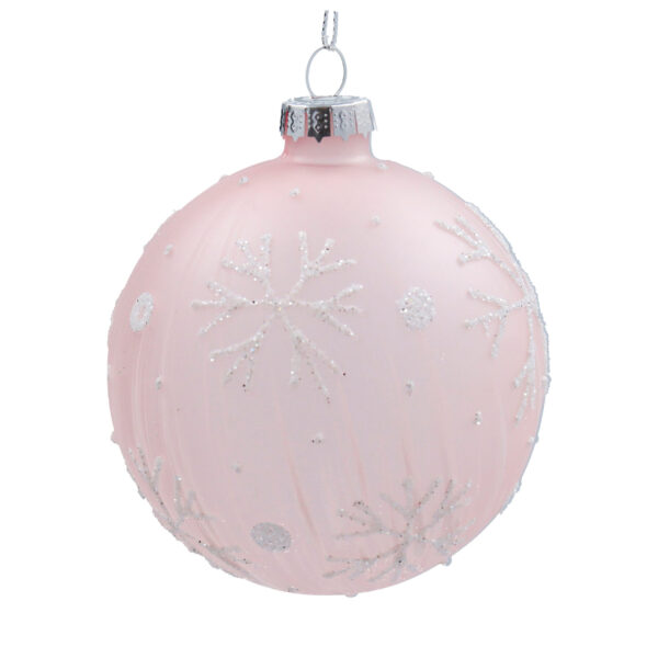 A matt pink glass Christmas tree bauble decorated with white glitter snowflakes and polka dots.