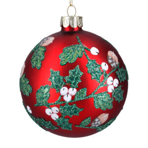 A matt red glass Christmas tree bauble decorated with green mistletoe and oak leaves accented with green glitter and white mistletoe berries and brown acorns..