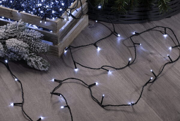 200 Bright White Fairy Lights (LED) in a crate on a wooden floor.