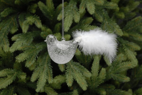 An Icy Effect Glass Bird with White Feathers ornament gracefully hanging from a tree branch, adorned with delicate white feathers.