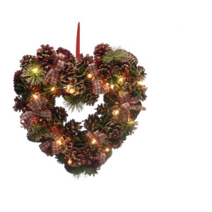 A Heart-Shaped Christmas Wreath decorated with natural pine cones with iridescent glitter frosting, Faux pine tree sprigs and red, white and green tartan ribbon bows. Warm white LED lights are interwoven through the wreath. It hangs from a red ribbon.