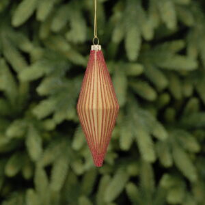 A matt gold, diamond shaped, ridged teardrop glass Christmas tree bauble decorated with fine lines of red glitter running down the edge of each ridge. Hanging from a gold string.