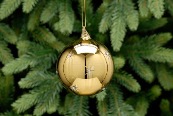 A gold metallic, glass Christmas tree bauble with small etched star that have tiny diamante jelwels in the centres. hanging from a gold string.