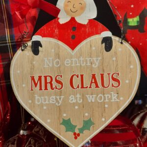 A wooden heart shaped 'No Entry: Mrs Claus busy at Work' Hanging Sign with metal loop for hanging with a red ribbon bow.