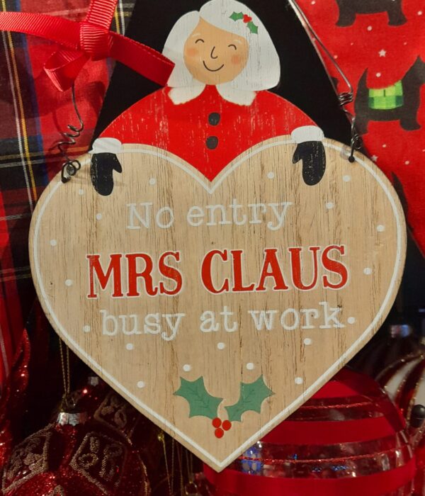 A wooden heart shaped 'No Entry: Mrs Claus busy at Work' Hanging Sign with metal loop for hanging with a red ribbon bow.