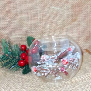 A Clear Glass and Berry Twig Tealight Candle Holder with a fosted brown twig with red holly berry decoration inside..