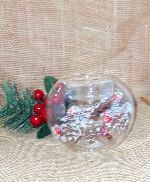 A Clear Glass and Berry Twig Tealight Candle Holder with a fosted brown twig with red holly berry decoration inside..