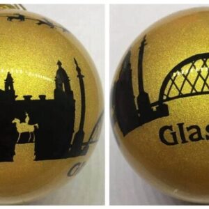 Beautiful handpainted glass Christmas tree bauble with the Glasgow Skyline in black against a gold glitter background. Santa in his sleigh being pulled by reindeer flys overhead and the text at the bottom reads 'Glasgow'.