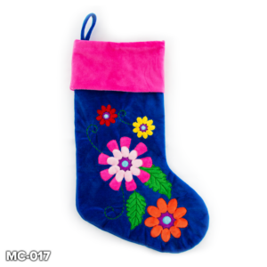 A Blue Velvet Floral Stocking with colourful appliqued flowers on the main body. The flowers are red, yellow, pink, purple and orange in colour and are connected to one another by green appliqued leaves and embroidered vines. The cuff of the stocking is hot pink velour and has a blue velour loop for hanging.