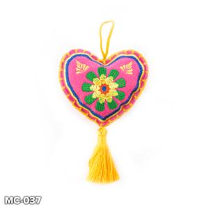 A pink felt, heart shaped Christmas tree decoration. This blue felt heart has a yellow and green flower embroidered in the centre and yellow and blue stitching around the outside. At the top there is a loop of yellow wool for hanging and a yellow tassel hangs from the point of the heart.