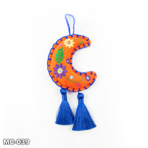 An orange felt, crescent moon shaped Christmas tree decoration. This orange felt moon has purple and yellow flowers and a green leaf embroidered in the centre and blue stitching around the outside. At the top there is a loop of blue wool for hanging and two blue tassels hangs from the base of the moon.