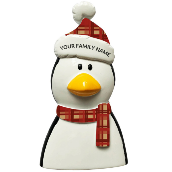 A polyresin Personalisable Christmas tree decoration in the shape of a penguins head. The peguin has two small black eyes and a large yellow beak and is wearing a tartan scarf and matching Santa hat, on the white trim of the hat there is black text that says 'YOUR FAMILY NAME' implying the decoration can be personalised.